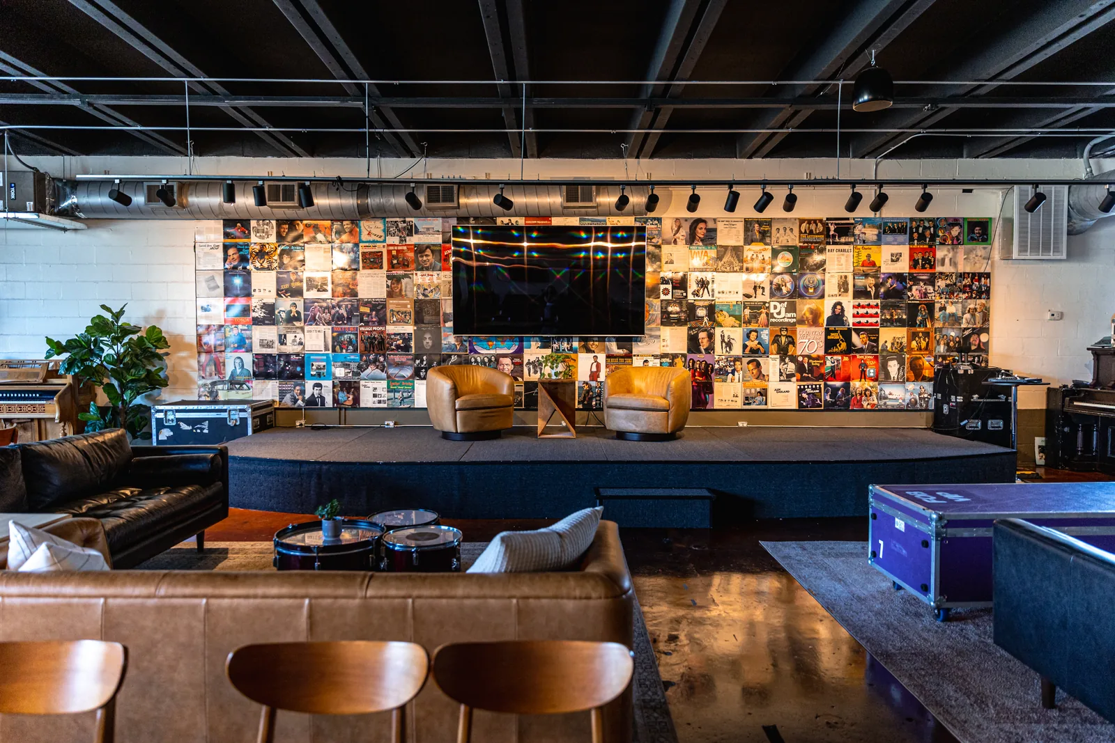 Stage, TV and lounge seating in the Music City Work Club event space